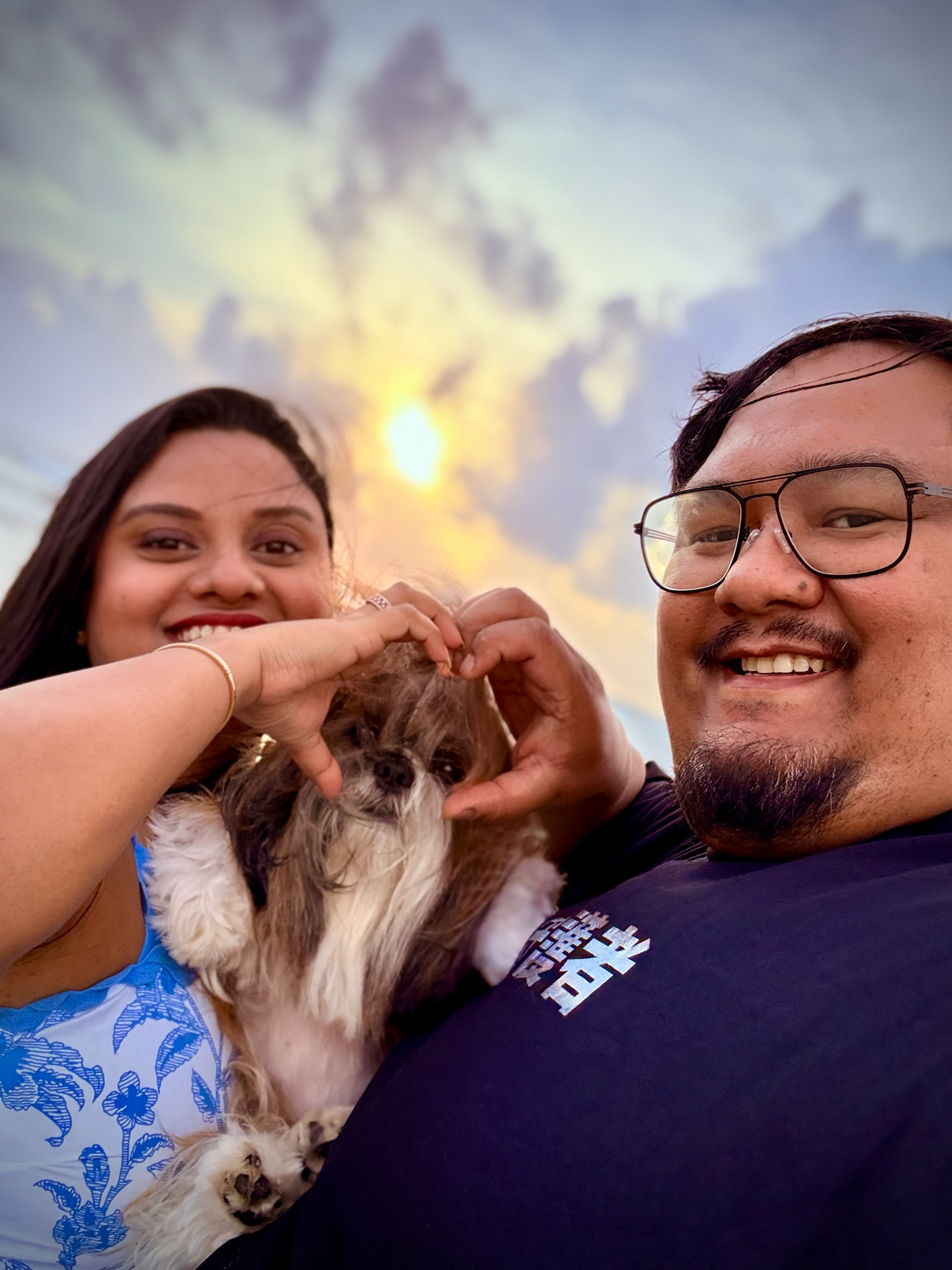 The family making a heart around Bunnu at sunset